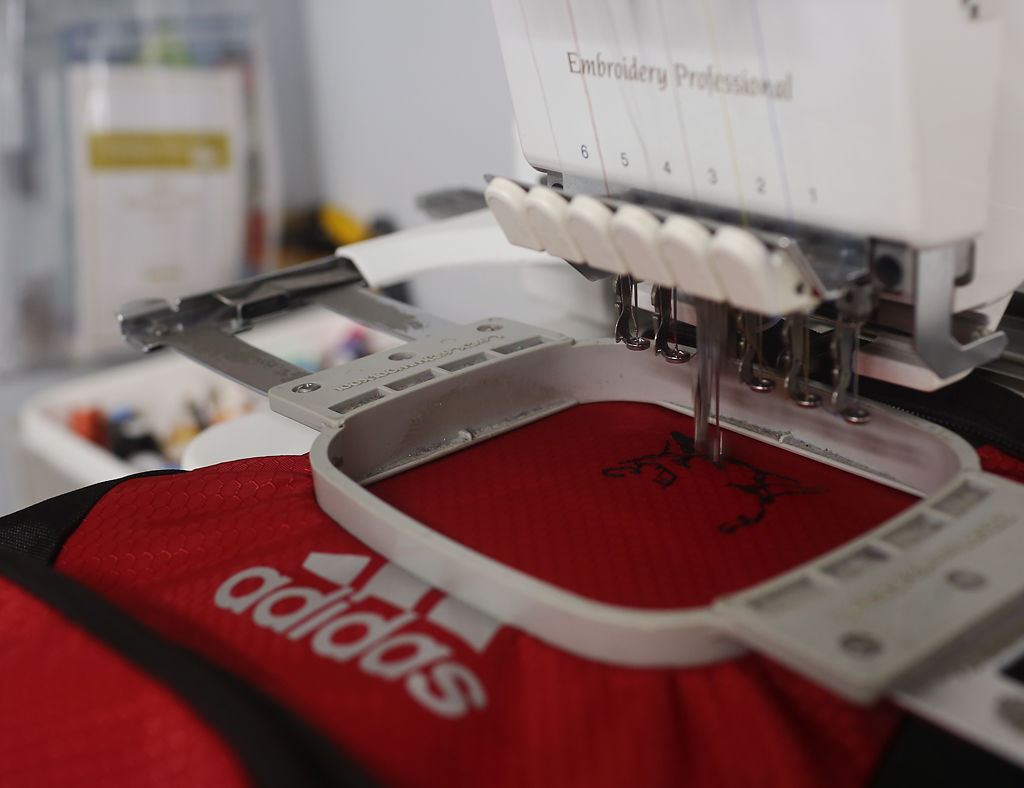 An embroidery machine stitches a wildcat